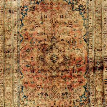 A yellow/orange stonwashed carpet with a classic motif in the middle